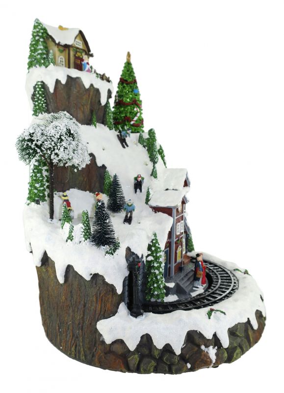 villaggio natalizio su montagna innevata con treno, movimento, luci, musica (35 x 46,5 x 36 cm)