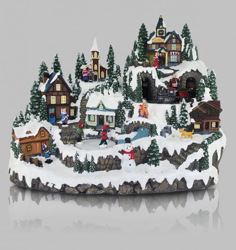 villaggio natalizio su montagna con treno e pista di pattinaggio in movimento, luci, musica (31 x 37,5 x 28,5 cm)